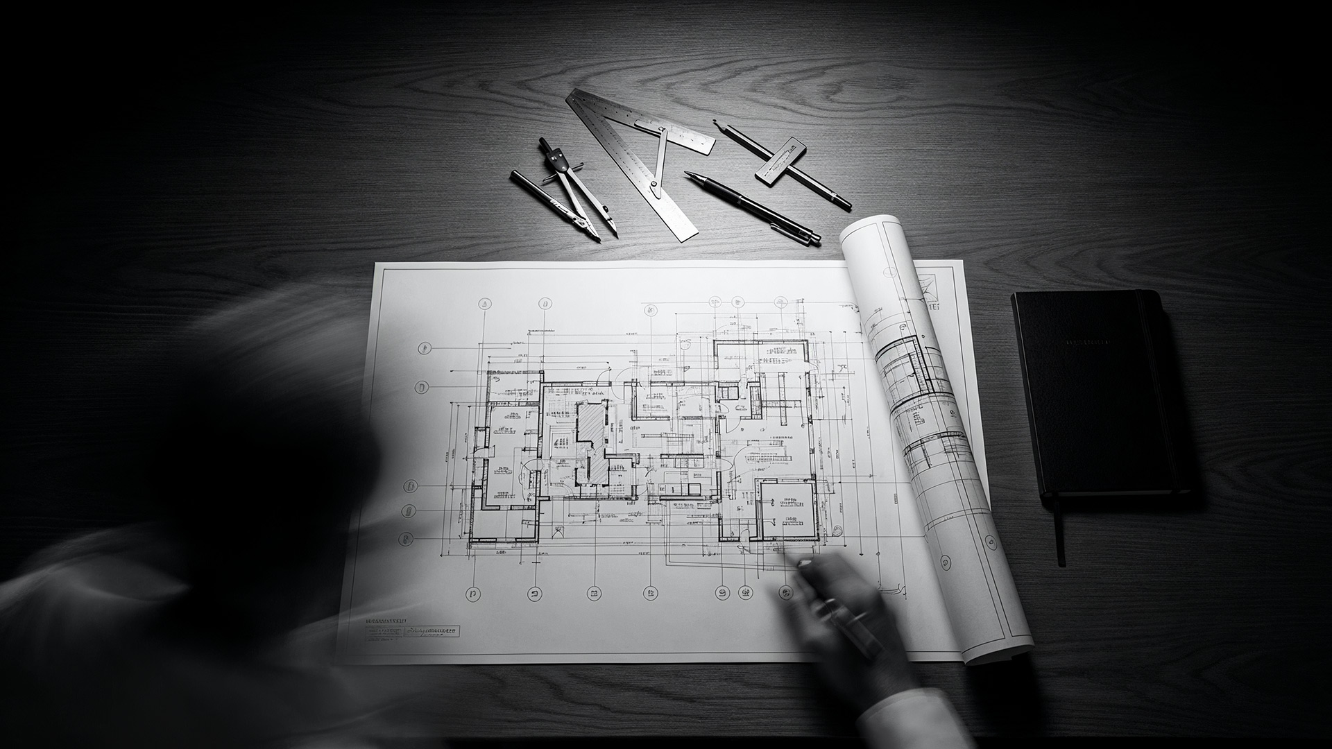 An architect's desk with an illuminated blueprint, symbolizing Presentation Studio's 'Strategy Before Style' methodology for engineering high-stakes business presentations.